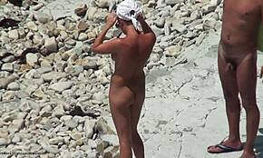 Bronasta vročica razkazuje osupljivo telo na plaži na prostem