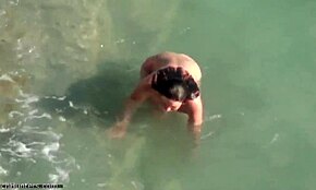 I can't believe this tan lines beauty showing off her sexy body on the beach, small tits and all