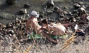Horny dude takes charge with his girlfriend on a nudist beach setting