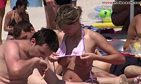 voyeur footage captures topless babes relaxing on sunny beach scenes