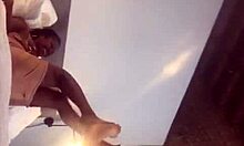 Ebony couple engages in intimate foot play on webcam with friend watching.
