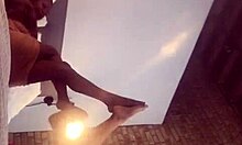 Ebony couple engages in intimate foot play on webcam with friend watching.