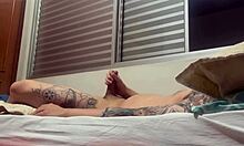 Intriguing solo amateur strokes his tattooed cock alone.