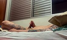 Intriguing solo amateur strokes his tattooed cock alone.