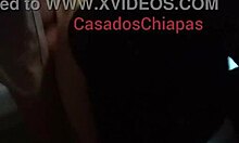 amateur latina poses in front of mirror with black dress