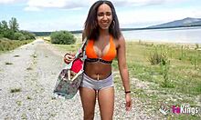 Ebony babe teases by the lake to attract any guy.