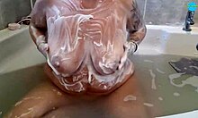 Milf soaping up her tits and ass in the bath