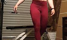 The muscular gym girl performs a teasing striptease