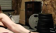 The muscular gym girl performs a teasing striptease