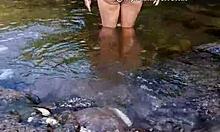 Brunette exhibitionist bathes in river naked