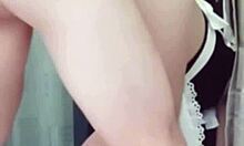 young girl cleans glass in maid outfit while cousin enters from behind