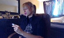 Sandi lights up 3 brown cork cigarettes, smoking seductively while teasing with her big tits.