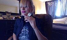 Sandi lights up 3 brown cork cigarettes, smoking seductively while teasing with her big tits.