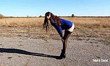 Leggy brunette shows off her tits in stockings outdoor