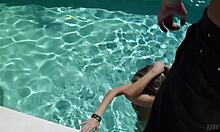 This cheerful teen girl is FINGERING her tight labia while soaking in the pool.