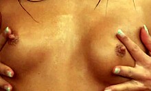 Totally naked brunette teases with her perfect body, getting soaked outdoors under the rain.