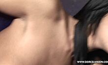 Two brunettes kissing in front of a naked man