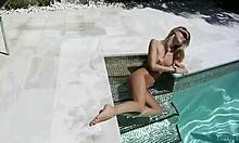 This cheerful teen girl is FINGERING her tight labia while soaking in the pool.