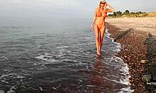 Stunning blonde bombshell teases in a red bikini while posing seductively just for your eyes in a solo striptease.