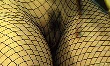 Brunette feels ecstasy in fishnets