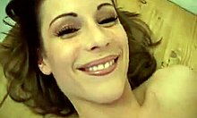 Lovely blonde in seductive white stockings pinches her nipples invitingly