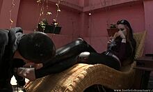 Redheaded Babe Chills Outdoors as Slave Worships Her Feet in Boots