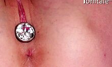 Blonde teen with butt-plug gets her tight pussy pounded by a toy until climax.