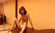 Why is this skinny teen brunette in colorful get-up posing seductively?