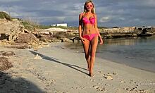 Holy crap, this amateur blonde flaunts massive jugs on the beach, ready to swallow cum!