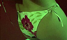 Emotionless blonde stares blankly while changing clothes in the room