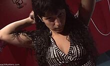 Brunette babe with curly mullet strips solo, flaunting big tits and panties on hidden cam.