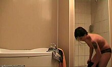 Short-haired chick showering in front of a random blonde