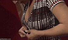 Brunette babe with curly mullet strips solo, flaunting big tits and panties on hidden cam.