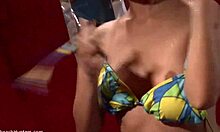 Smug tanned brunette showers seductively