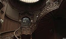 Posing naked in an old stylish building showcases a perfect body