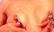 Long-haired skinny beauty with oily body prepares to insert anal beads into her pussy on webcam