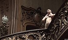 Posing naked in an old stylish building showcases a perfect body