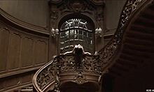 Posing naked in an old stylish building showcases a perfect body