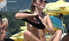 Two tanned blonde girls boldly sunbathing topless on the beach today.