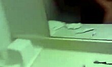 Dark-haired gal holding onto the wall while being fucked doggystyle in front of a mirror