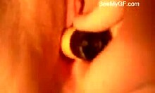 Horny slut inserts large toy into shaved pussy during solo close-up