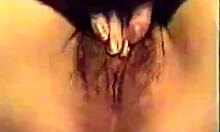 girl with red nails fingers her unshaved pink pussy