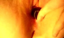 Horny slut inserts large toy into shaved pussy during solo close-up