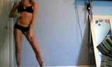 Slender blondie poses proudly in black lingerie