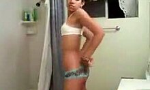 a petite latina undresses and dances in the bathroom for webcam