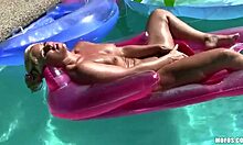 inked chick in pink underwear prepping for poolside sunbathing fun