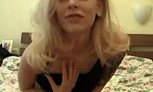 Babe with tattoo shoving dildo in shaved pussy while fantasizing about porn