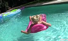 inked chick in pink underwear prepping for poolside sunbathing fun