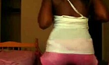 Exotic ebony woman dances and poses in shorts on webcam, showcasing her fabulous designer outfit.