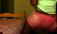 Exotic ebony woman dances and poses in shorts on webcam, showcasing her fabulous designer outfit.